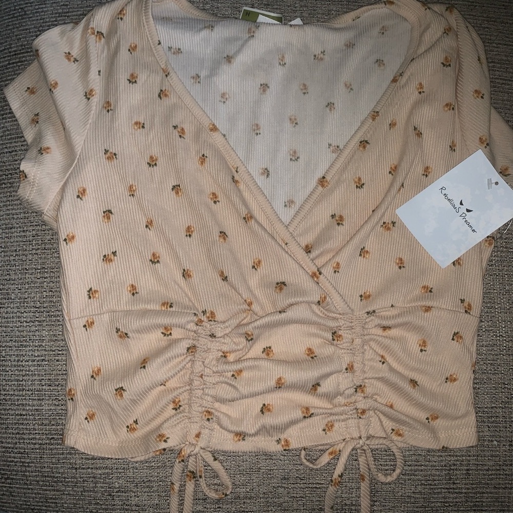 Light tan short sleeve crop top with flower details